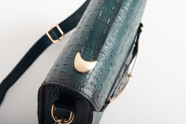 CLUTCH BAG WITH DECORATIVE METAL ACCESSORIES AND HANDLE IN DARK GREEN