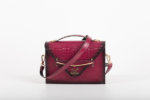 CLUTCH BAG WITH DECORATIVE METAL ACCESSORIES AND HANDLE IN MAGENTA