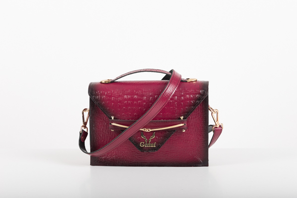 CLUTCH BAG WITH DECORATIVE METAL ACCESSORIES AND HANDLE IN MAGENTA