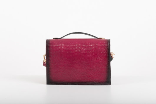 CLUTCH BAG WITH DECORATIVE METAL ACCESSORIES AND HANDLE IN MAGENTA