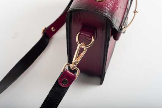 CLUTCH BAG WITH DECORATIVE METAL ACCESSORIES AND HANDLE IN MAGENTA