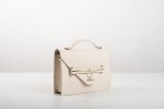 CLUTCH BAG WITH DECORATIVE METAL ACCESSORIES AND HANDLE IN CREAM